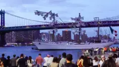 People look at Mexican Navy training ship Cuauhtémoc after it crashed into New York City's Brooklyn Bridge.