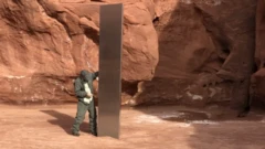 A wildlife official stands by the monolith