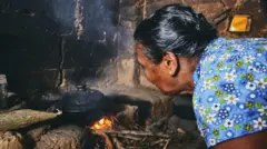 

Rural woman preparing food in traditional home kitchen. Domestic life in Sri Lanka.