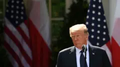 US President Donald Trump looks on during a joint press conference at the White House