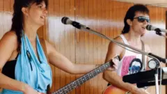 Tracy and Moss performing on board a cruise ship
