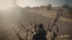 A Hamas fighter inside a cage carried by a parachute and pointing a gun