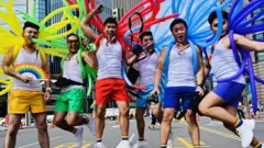 Participants jump in a pose while taking part in the annual gay pride parade in Taipei
