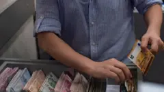 man counting money
