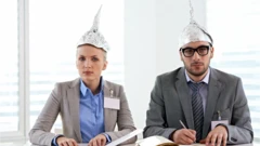 Woman and man wearing tinfoil hats