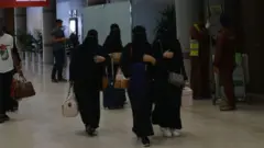 A picture taken during a guided tour with the Saudi military on 13 June 2019 shows Saudi women arriving at Abha airport in the popular mountain resort of the same name in the southwest of Saudi Arabia