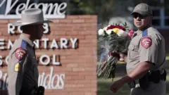 Police lay flowers at the scene