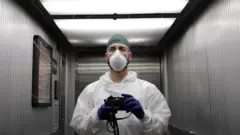 A member of hospital staff with a camera