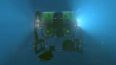 Um veículo submarino operado remotamente (ROV) no meio do azul do mar