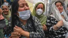 অজ্ঞাত বন্দুকধারীদের হামলায় নিহত স্কুল শিক্ষকের পরিবারের শোকাহত সদস্যরা