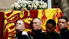 Pallbearers carrying the coffin of Queen Elizabeth II