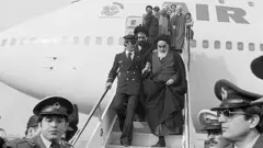 Ayatollah Ruhollah Khomeini steps out of the Air France plane which brought him back to Tehran