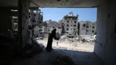 Palestinian families return their homes among the rubbles of destroyed buildings after Israeli forces' withdrew from the city leaving behind massive destruction in Khan Younis, Gaza on 11 April, 2024.
