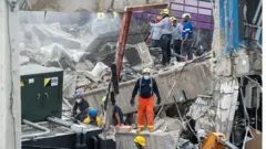 Rescuers at the collapsed nightclub