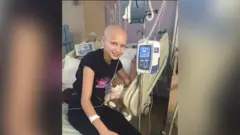 Ellie Waters-Barnes aos 14 anos, em uma cama de hospital.
