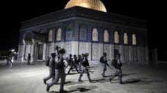 Israeli police walk near di Dome of di Rock during clashes wit Palestinians, 7 May
