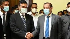 Former secretary to the Ministry of Defence, Hemasiri Fernando (centre R), and former police chief Pujith Jayasundara 