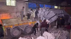 Palestinian workers were pictured unloading sacks of flour at a bakery in the southern city of Khan Younis overnight