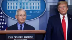 US President Donald Trump looks at National Institute of Allergy and Infectious Diseases Director Dr Anthony Fauci as he answers a question during the daily Coronavirus task force briefing at the White House in Washington, 17 April, 2020.