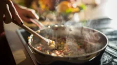 Hot steaming pan with paella rice dish in it 