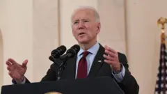 US President Joe Biden speaks about lives lost to Covid after death toll passed 500,000, in the Cross Hall of the White House in Washington, DC, February 22, 2021.