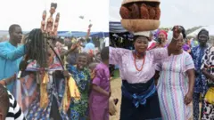 Egungun to wa ninu ẹku mu igi kan lọwọ pẹlu ero lẹyin rẹ, ati mama agba to ru igba lori pẹlu ilẹkẹ lọrun 