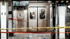 Пассажиры поезда проезжают мимо места нападения, 11 апреля 2026 года в метро на станции «Гранд Сентрал» в Нью-Йорке (США).