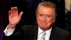 Television host Regis Philbin waves goodbye during his final show of on ABC's Live With Regis and Kelly in New York, November 18, 2011