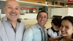 The reunited family with their lawyer at Melbourne Airport on 10 December 2020