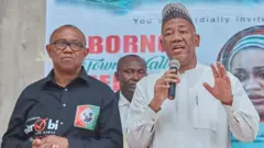 Peter Obi wear black shirt, and Datti wear kaftan holding mic