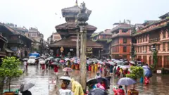 भक्तपुरको दत्तात्रय मन्दिरमा पानीमा रुझ्दै लाइन लागेका मानिसहरू