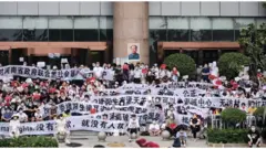 數以百計的村鎮銀行儲戶與警方對峙，並遭到身份不明的人士毆打。