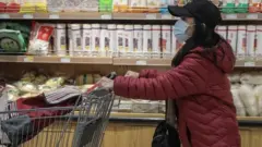 A woman shops in a supermarket in Beijing, China, 02 November 2021.
