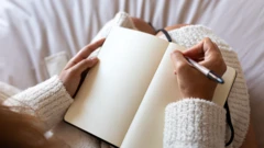 Uma mulher com uma caneta e um caderno em branco