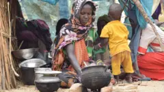 نازحة سودانية تطهي