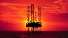 دکل نفتی در دریا و غروب آفتاب