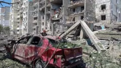 A damaged car in front of a destroyed building in Serhiyivka, Odesa region, Ukraine. Photo: 1 July 2022