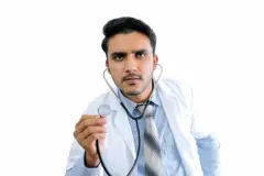 Funny doctor with stethoscope on white background - stock photo
