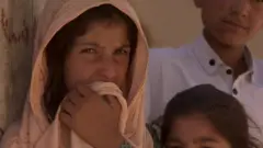 A villager and her family in the eastern province of Logar in Afghanistan