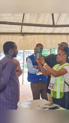 Election officials and a voter