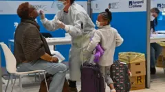 Visitor being tested for Covid-19 at Rome Fiumicino airport, 9 Dec 20