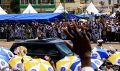 Le président camerounais Paul Biya dans son véhicule saluant une foule de partisans