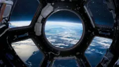 Planeta Terra visto de dentro da Estação Internacional, através de espécie de janela