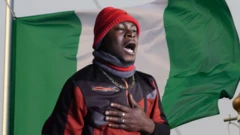 Nigerian wey return from Libya dey sing national anthem