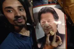 इमरान खानका एक कार्यकर्ता उनको तस्बिरसँगै मिठाई बोकेर हर्षोल्लास गर्दै