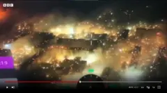 Reprodução de imagem de drone sobre a cidade de Bakhmut, em chamas
