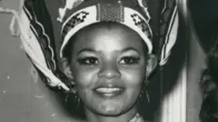 A black-and-white close up image of Cynthia Shange smiling