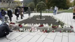 People in Kongsberg place tributes for the dead after an attack which left five people dead in the town