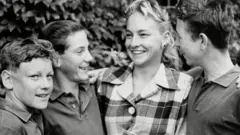Wimbledon ball boys meet Darlene Hard, women's singles runner-up, at the 1957 Wimbledon Championship