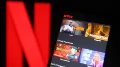 Netflix logo with Netflix on phone